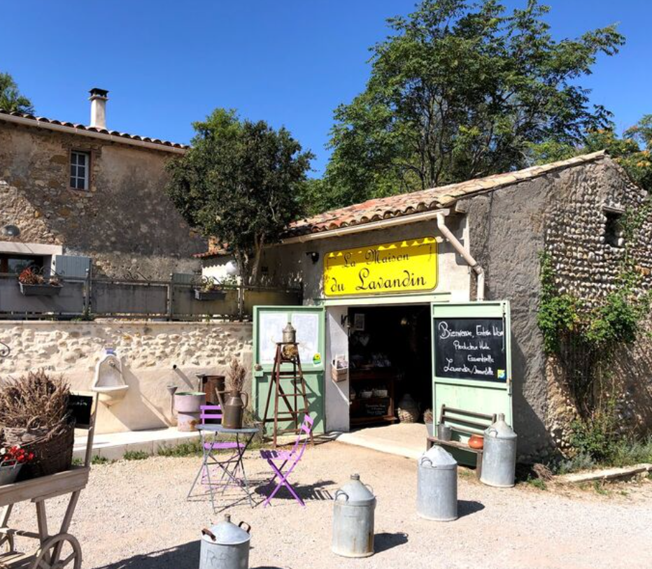 Traditional stone building with a yellow sign in a rural setting